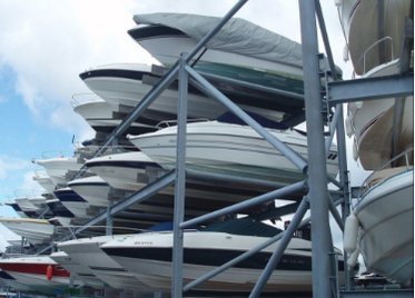 Picture of multiple boats suspended on outdoor boat storage racks in Miami Florida.