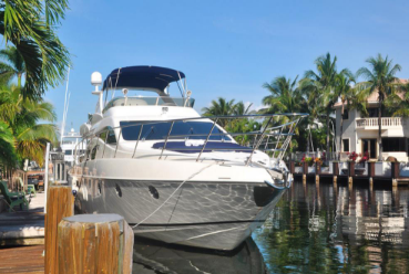 Yacht receiving dock side service and tune up while tied up in a canal in south Florida.